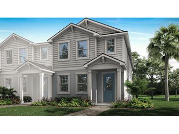 Charming two-story home with a blue front door and inviting, landscaped yard at 3073 Douglas Fir Dr, Apopka, FL 32703