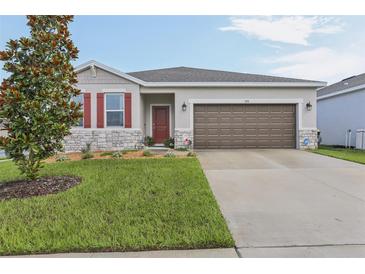 Charming single-story home with a well-manicured lawn and inviting curb appeal at 394 Quayside Ave, Mascotte, FL 34753