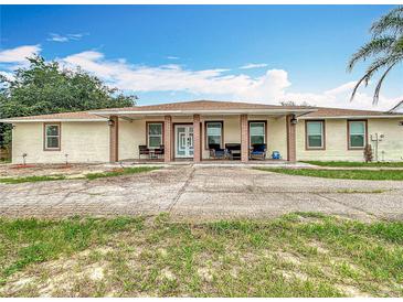 Charming one-story home with a long driveway and front porch offers curb appeal and ample parking at 516 Petes Ln, Davenport, FL 33837
