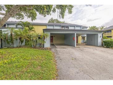 Townhouse with a covered carport, well maintained lawn, and tasteful landscaping at 7475 Canford Ct # 21, Winter Park, FL 32792