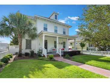 Charming two-story home with a welcoming front porch, lush lawn and well-manicured landscaping at 859 Easley Ave, Winter Garden, FL 34787