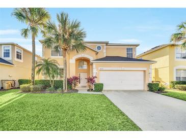 Charming two-story home features a well-manicured lawn and a two-car garage at 8622 La Isla Dr, Kissimmee, FL 34747