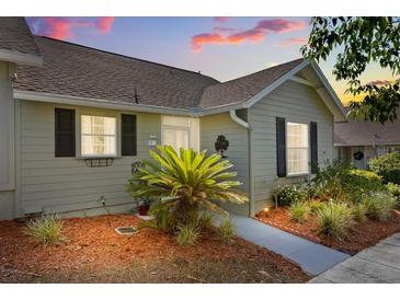 Inviting home exterior featuring tidy landscaping, a walkway, and neutral siding at 1126 Villa Ln # 91, Apopka, FL 32712