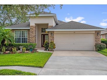 Charming single-Gathering home featuring stone accents and a well-manicured front lawn at 1171 Lebanon Ct, Sanford, FL 32771
