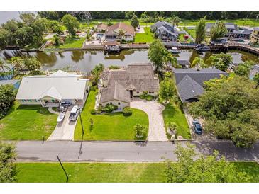 Stunning aerial view of waterfront home with lush landscaping, private dock, and beautiful curb appeal at 1721 Perch Ln, Sanford, FL 32771
