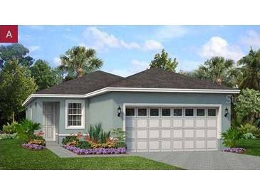 Charming single-story home featuring a two-car garage and well-manicured landscaping at 196 Duckweed Ave, Fruitland Park, FL 34731