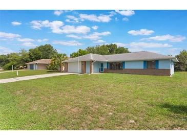 Charming one-story home with a well-manicured lawn and attached garage at 2290 Carson Ln, Deltona, FL 32738