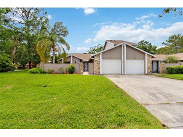 Charming home featuring attached garage, and a beautifully maintained green lawn at 244 Surf Scooter Dr, Daytona Beach, FL 32119