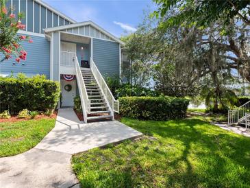 Charming two-story condo with well-maintained landscaping and a welcoming entrance at 2533 Grassy Point Dr # 215, Lake Mary, FL 32746