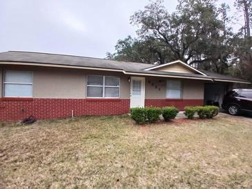 Charming single-story home featuring brick accents and a well-maintained front lawn at 4225 Ne 25Th Ave, Ocala, FL 34479