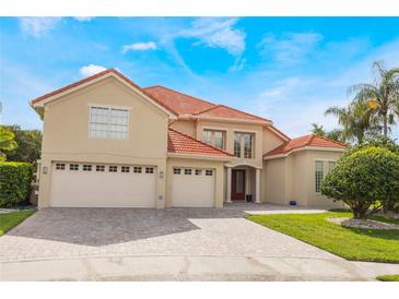 Stunning two-story home featuring a three-car garage, tile roof, and a lush, green lawn at 9062 Dancy Tree Ct, Orlando, FL 32836
