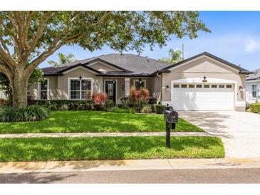 Charming single-story home with a well-manicured lawn and mature landscaping at 1154 Kerwood Cir, Oviedo, FL 32765