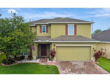 Charming two-story home with manicured lawn and a two-car garage at 144 Williamson Dr, Davenport, FL 33897