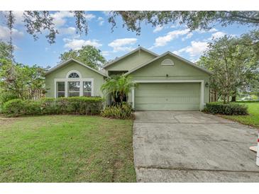 Charming single-story home featuring a two-car garage and lovely, low-maintenance landscaping at 16103 Denham Ct, Clermont, FL 34711