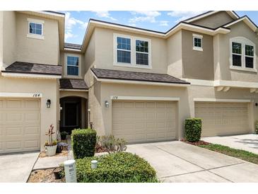 A beautiful townhome with a well-kept lawn, an attached garage, and lovely curb appeal at 178 Windflower Way, Oviedo, FL 32765
