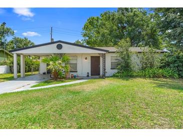 Charming single-story home featuring a quaint front yard and a convenient carport at 1877 Attucks Ave, Orlando, FL 32811