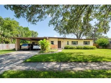 Charming single-story home with a well-manicured lawn and covered carport at 1901 Loch Berry Rd, Winter Park, FL 32792
