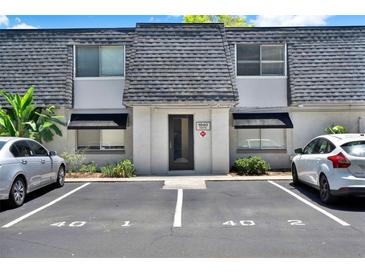 Charming townhouse with well-maintained landscaping and dedicated parking spaces out front at 1940 S Conway Rd # 8, Orlando, FL 32812