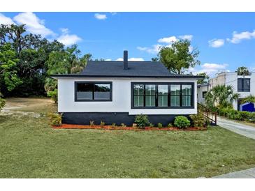 Charming renovated bungalow featuring black and white exterior paint and new windows at 209 N 14Th St, Leesburg, FL 34748