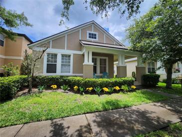 Charming home featuring a well-manicured front yard and inviting porch with decorative columns at 2246 Florida Soapberry Blvd, Orlando, FL 32828