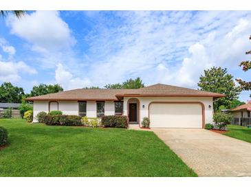 Charming single-story home with a well-maintained lawn, brick trim, and an attached two car garage at 8988 Angelica Dr, Orlando, FL 32836