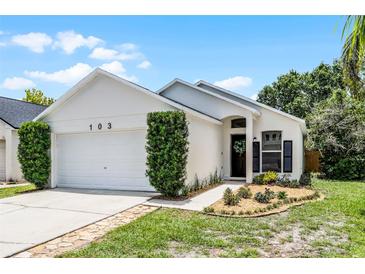 Charming single-story home with well-maintained landscaping and a two-car garage in a suburban neighborhood at 103 Gleason Cv, Sanford, FL 32773