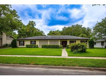 Charming single-story home featuring well-maintained landscaping and a welcoming facade on a sunny day at 1171 Covewood Trl, Maitland, FL 32751