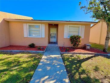 Charming single-story home with a well-maintained front yard and walkway leading to the front door at 2357 Rio Pinar Lakes Blvd, Orlando, FL 32822