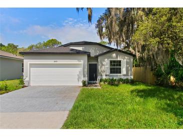 Charming single-story home with a well-maintained lawn, a two-car garage, and curb appeal at 3672 Rollin O Ln, Apopka, FL 32703