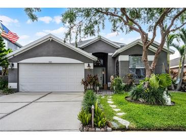 Charming single-Gathering home with well-manicured lawn and two-car garage at 545 Hardwood Cir, Orlando, FL 32828