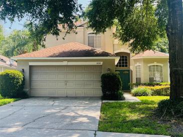 Two-story home featuring an attached two-car garage and a well maintained lawn at 830 Moonlit Ln, Casselberry, FL 32707