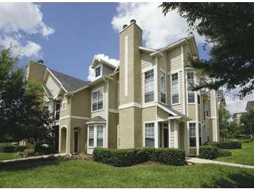 Inviting multi-level home with well-manicured lawn and mature trees, creating a picturesque curb appeal at 1101 Vintage Village Ln # 106, Ocoee, FL 34761