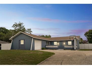 Charming single-story home featuring an attached garage, basketball hoop, and well-manicured lawn at 1167 Lake Blanche Dr, Orlando, FL 32808