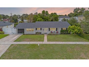 Charming single story home boasting a well-manicured lawn, lovely landscaping, and a freshly painted exterior at 1328 Vassar St, Orlando, FL 32804