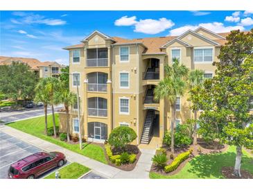 Beautiful condo building featuring balconies, lush landscaping and convenient parking at 2821 Almaton Loop # 105, Kissimmee, FL 34747