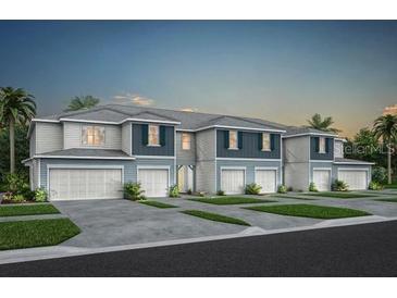 New townhome building featuring two-story construction, painted siding, and individual garages at 3342 Canyon Bay Pt, Sanford, FL 32773