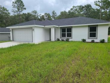 Charming single-story home featuring a two-car garage and a well-maintained lawn at 4333 Sw 157Th Ter, Ocala, FL 34481