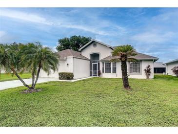 Charming single-story home features a well-manicured lawn and tropical palm trees at 5517 W Sacramento Ct, Orlando, FL 32821