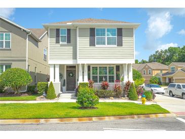 Charming two-story home with meticulously landscaped front yard and inviting curb appeal on a sunny day at 888 Wakulla Ln, Winter Springs, FL 32708