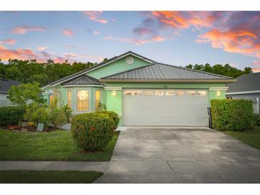 Charming single-story home showcasing a lush green lawn, mature shrubs, and a two-car garage, radiating curb appeal at 1028 Ocala Woods Ln, Orlando, FL 32824