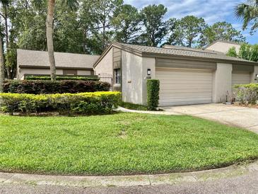 Charming home with lush landscaping and a well-maintained lawn at 1110 Woodbine Street, Fern Park, FL 32730