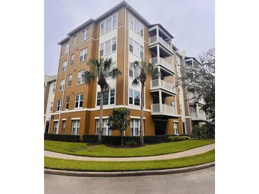 Stunning multi-story condo building with private balconies and well-maintained landscaping at 1200 Ironsmith Dr # 508, Celebration, FL 34747