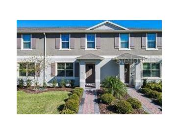 Charming townhome featuring a well-manicured lawn and tasteful exterior color scheme at 12035 Holystone St, Winter Garden, FL 34787