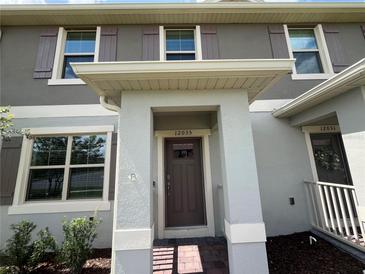 Charming home front entrance, featuring a brick walkway and a covered entryway at 12035 Holystone St, Winter Garden, FL 34787