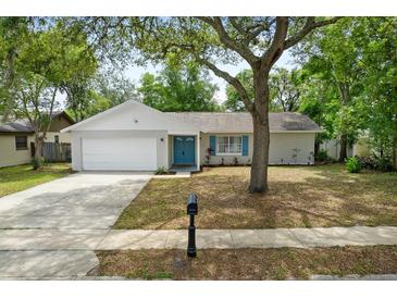 Charming single-story home featuring a well-manicured lawn, mature trees, and a cozy, inviting entrance at 1514 Sparrow St, Longwood, FL 32750