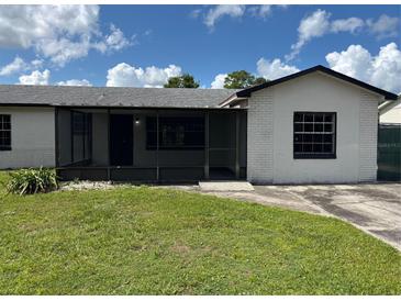 Charming single-story home with a screened porch, freshly painted exterior, and well-maintained lawn at 2085 San Jose Blvd, Orlando, FL 32808