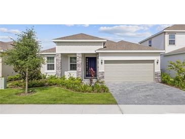 Charming single-story home featuring a two-car garage, well-manicured lawn, and inviting front entrance at 2292 Sirena Ln, Mount Dora, FL 32757
