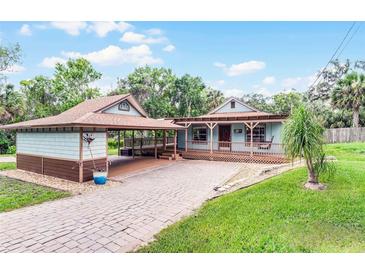 Charming single-story home with a welcoming porch, brick driveway, and covered parking at 740 Florida Blvd, Altamonte Springs, FL 32701