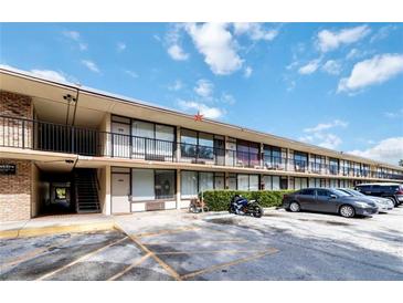 Motel exterior featuring an outdoor balcony and ample parking at 7900 S Orange Blossom Trl # 2108, Orlando, FL 32809