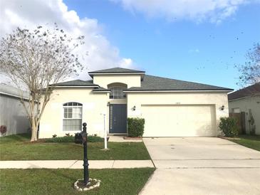 Charming single-story home with a well-manicured lawn, a two-car garage and welcoming curb appeal at 10513 Leader Ln, Orlando, FL 32825